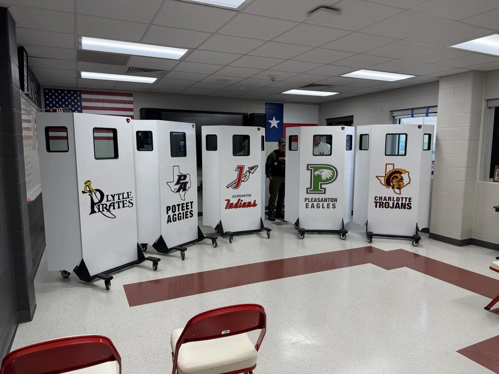 Five Falcon Shields lined up in a Texas school, each branded with a district mascot: Lytle Pirates, Poteet Aggies, Jourdanton Indians, Pleasanton Eagles, and Charlotte Trojans